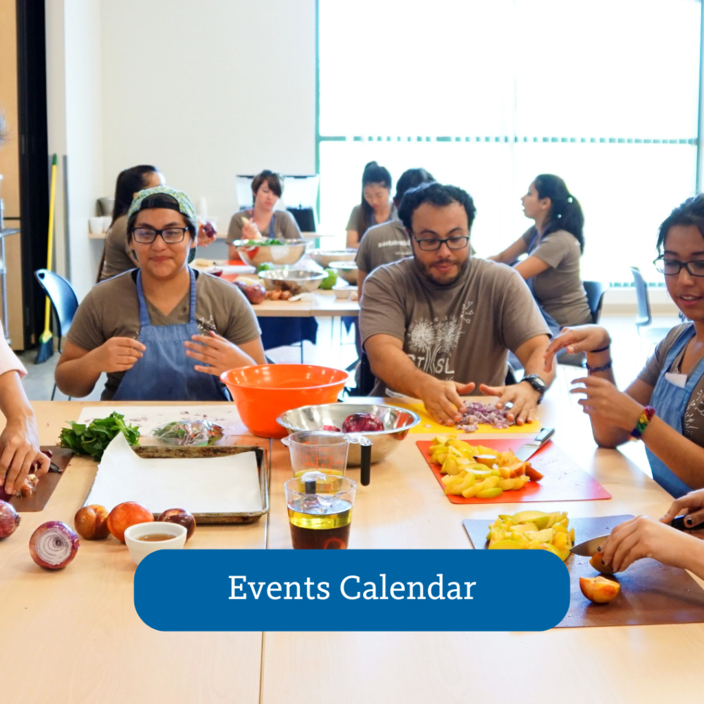 group of people sitting at tables with food and kitchen equipment, Events Calendar button overlayed onto photo.