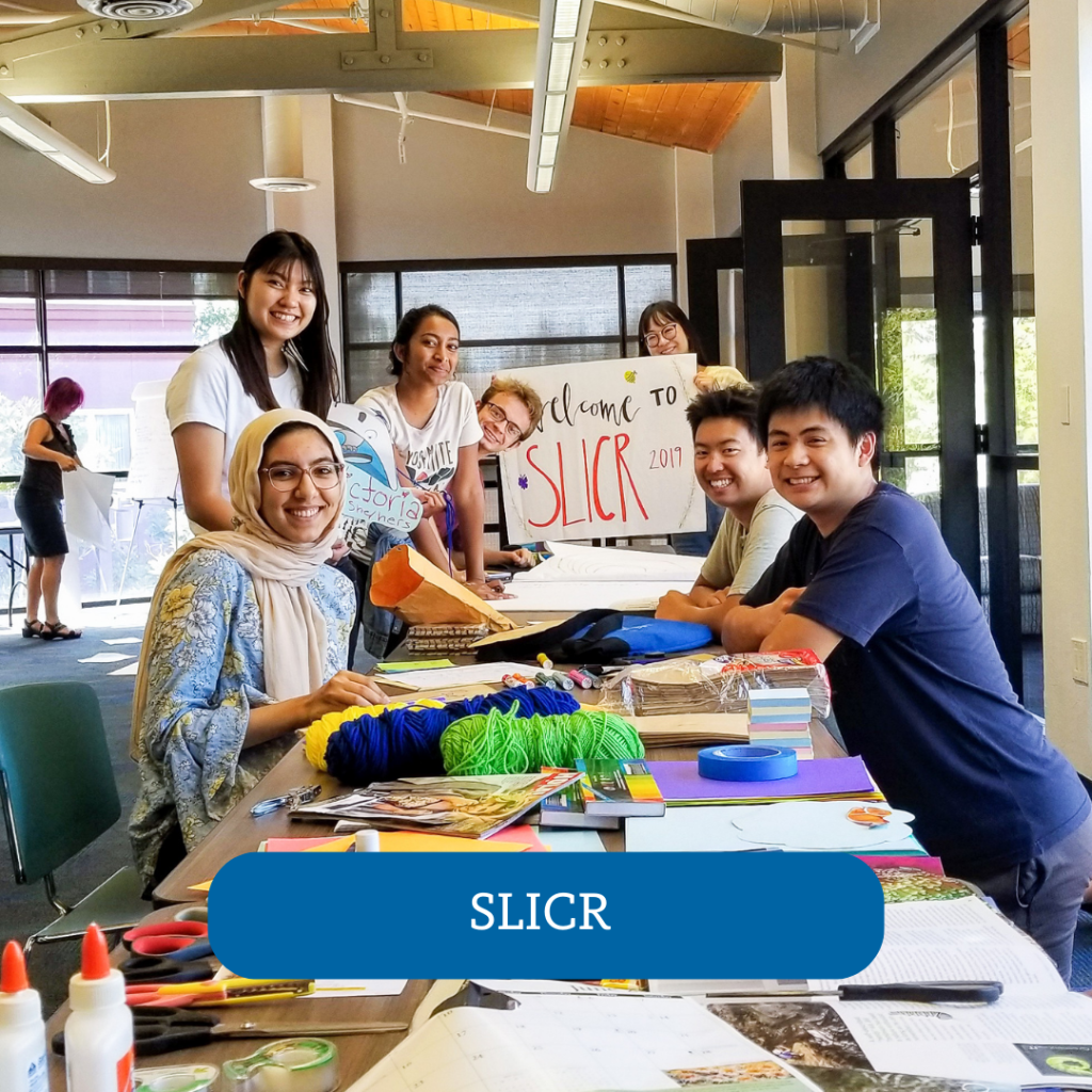 group of people at a table holding a sign that says Welcome to SLICR, SLICR button overlayed onto the photo